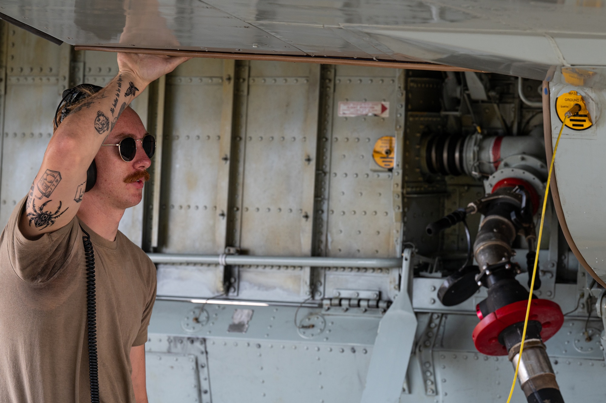 U.S. Air Force Senior Airman Michael Howard, 95th Reconnaissance Squadron crew chief, watches over the fuel hose connection during the first hot-pit refueling of a RC-135 Rivet Joint aircraft at Royal Air Force Mildenhall, England, Aug. 14, 2023.
