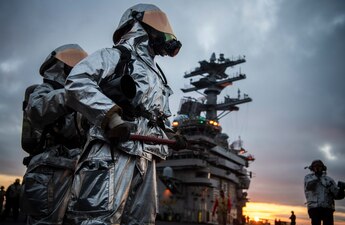 Sailors participate in a firefighting drill on the flight deck of aircraft carrier USS Nimitz (CVN 68). Nimitz is currently underway conducting routine operations. Nimitz is underway conducting routine operations.