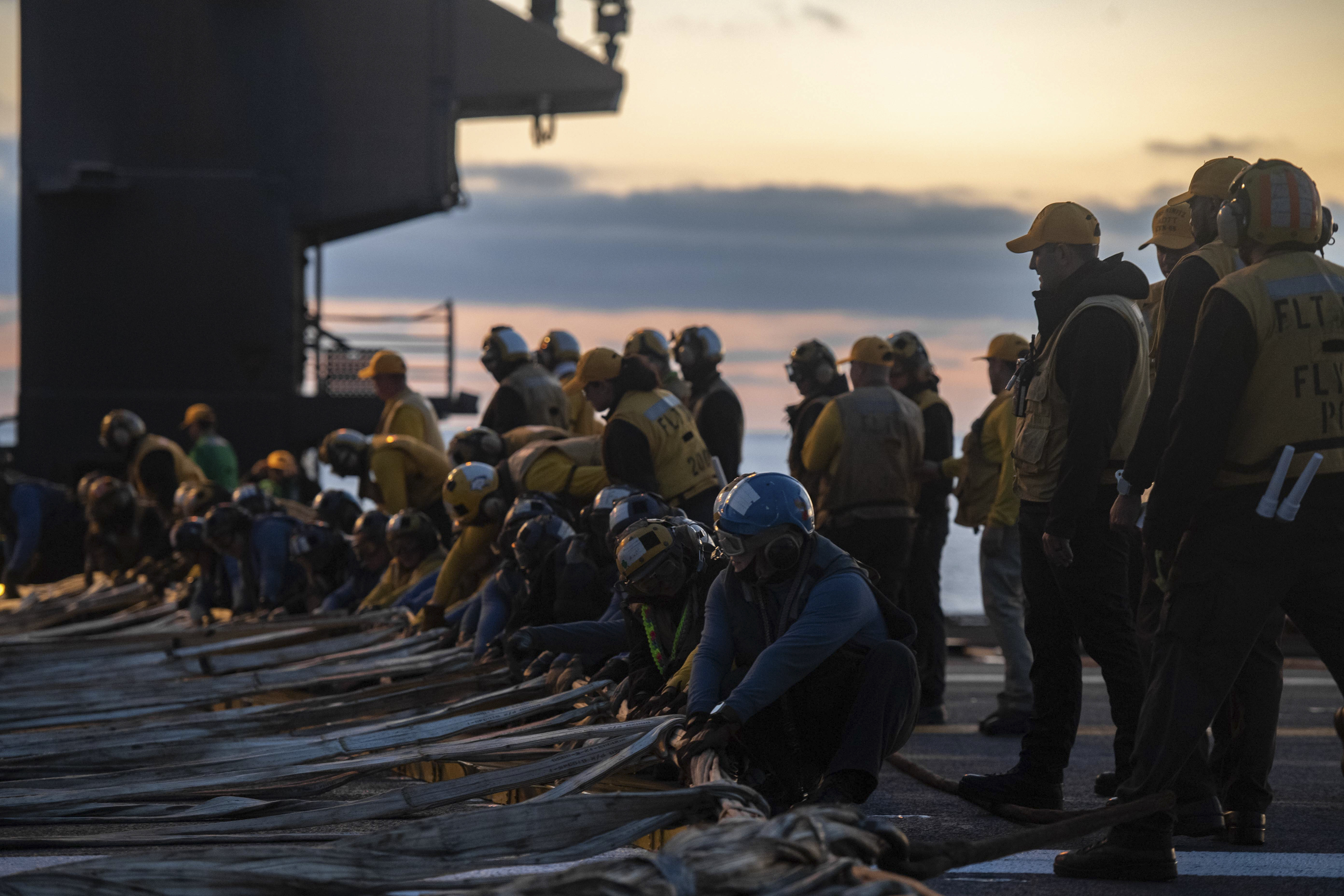 Sailors rig the barricade in a flight deck drill on aircraft carrier USS Nimitz (CVN 68). Nimitz is currently underway conducting routine operations.
