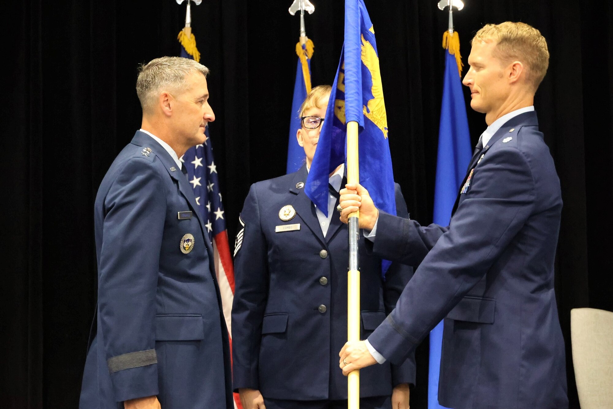 Photos show the passing of the guidon from the outgoing to the incoming AFRCC commander. The Air Force Rescue Coordination Center here held a change of command ceremony on August 1, 2023. Lt. Col. Matthew Mustain relinquished command to Lt. Col. Ryan Sealy. Lt. Gen. Nordhaus, commander of the Continental U.S. North American Aerospace Defense Region – First Air Force (Air Forces Northern and Air Forces Space) presided over the ceremony.