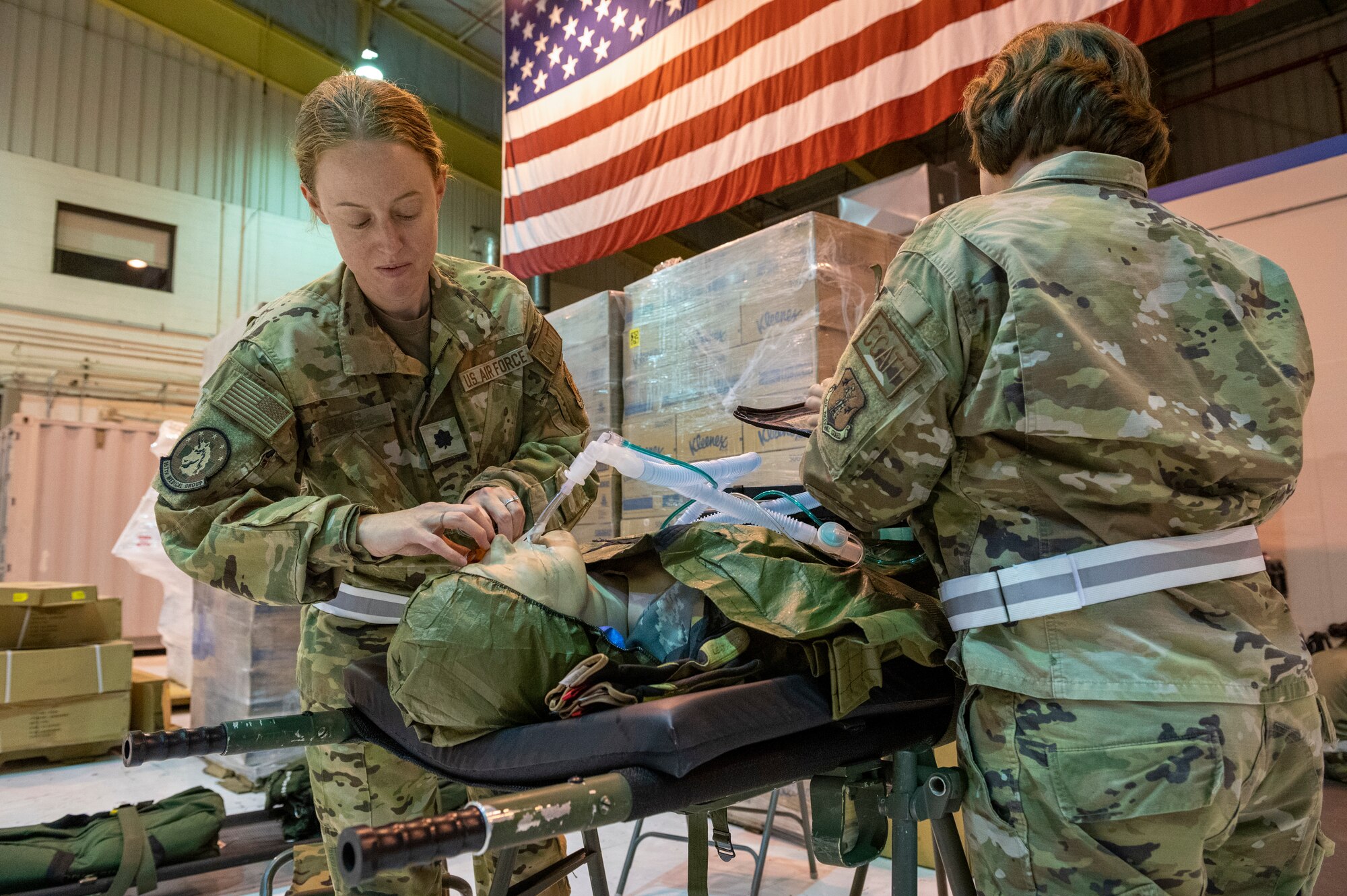 U.S. Air Force Lt. Col. Katie Ellis, 167th Medical Group critical care physician, and Lt. Col. Lori Wyatt, 167th Medical Group critical care nurse, conduct a preflight assessment of a simulated patient during a readiness exercise at the 167th Airlift Wing, Martinsburg, West Virginia, Aug. 11, 2023.