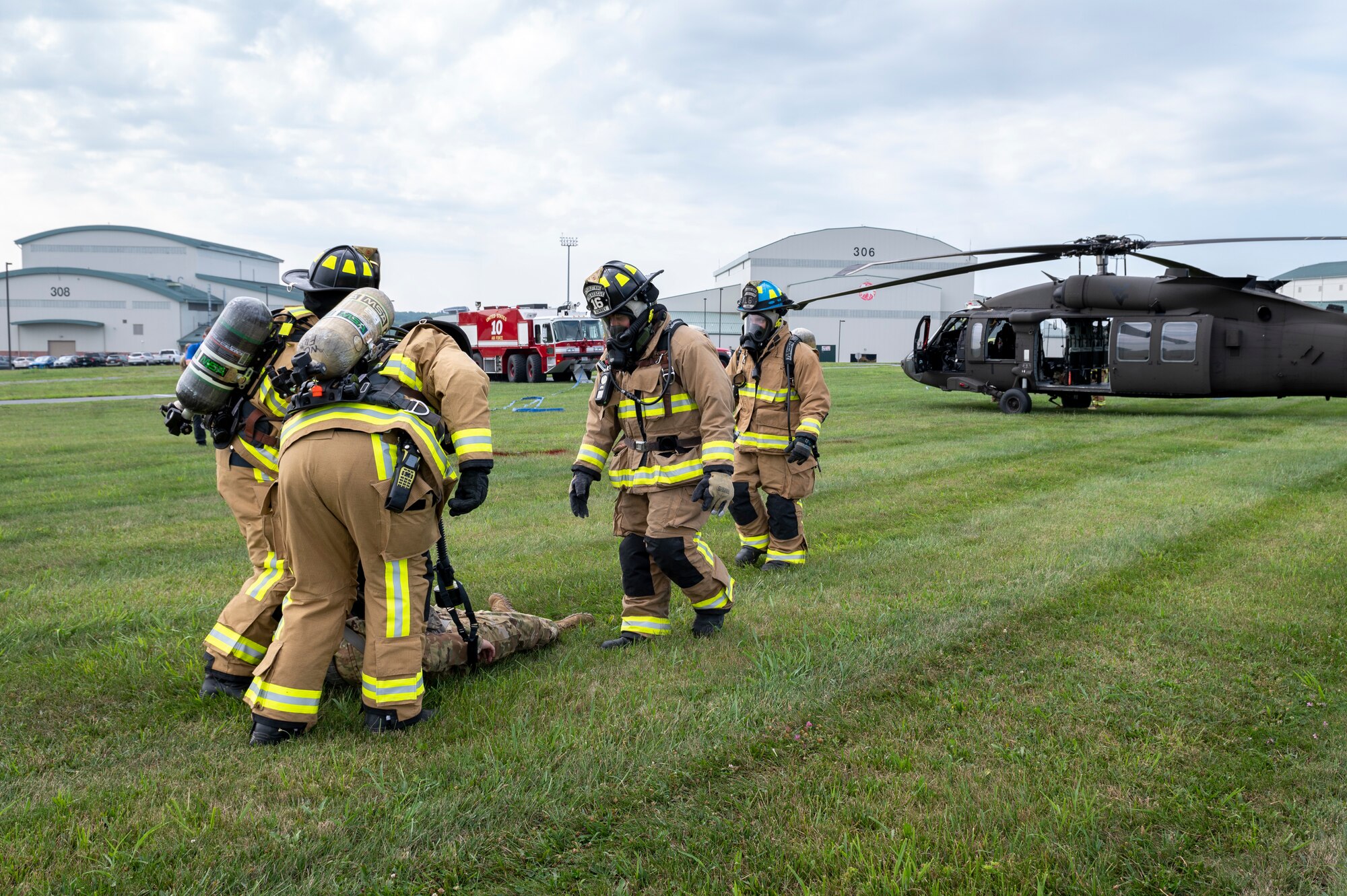 Firefighters with the 167th Airlift Wing tend to a simulated casualty during a UH-60M Black Hawk helicopter crash landing incident response as part of a readiness exercise at the 167th Airlift Wing Martinsburg, West Virginia, Aug, 12, 2023