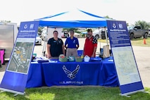 Lynda LaFond, Natural and Cultural Resources Program Manager, 5th Civil Engineer Squadron, Abigail Kinder, Community Relations Advisor, 5th Bomb Wing Public Affairs, and Ray Sumner, xxx, man an educational booth at the Mandan-Hidatsa-Arikara (MHA) Nation’s Little Shell Celebration in New Town, N.D., Aug. 10-13, 2023. The Air Force representatives attended the powwow to provide information on the Sentinel weapon system project to members of MHA Nation and build relationships. (U.S. Air Force photo by Abigail Kinder)