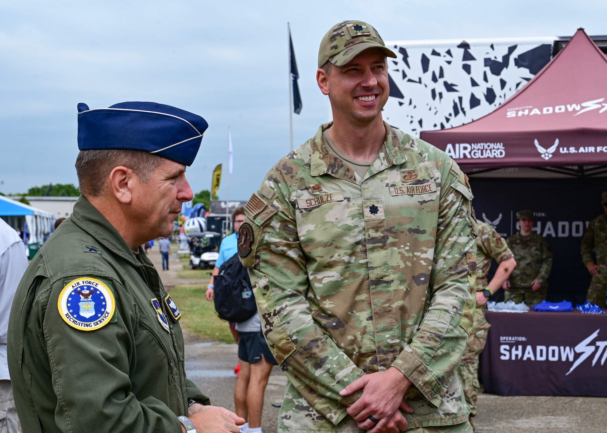 Brig. Gen. Christopher Amrhein, Air Force Recruiting Service commander, speaks with Lt. Col. Benjamin Schulze, 347th Recruiting Squadron commander, during EAA AirVenture Oshkosh, in Oshkosh, WI, July 26, 2023.