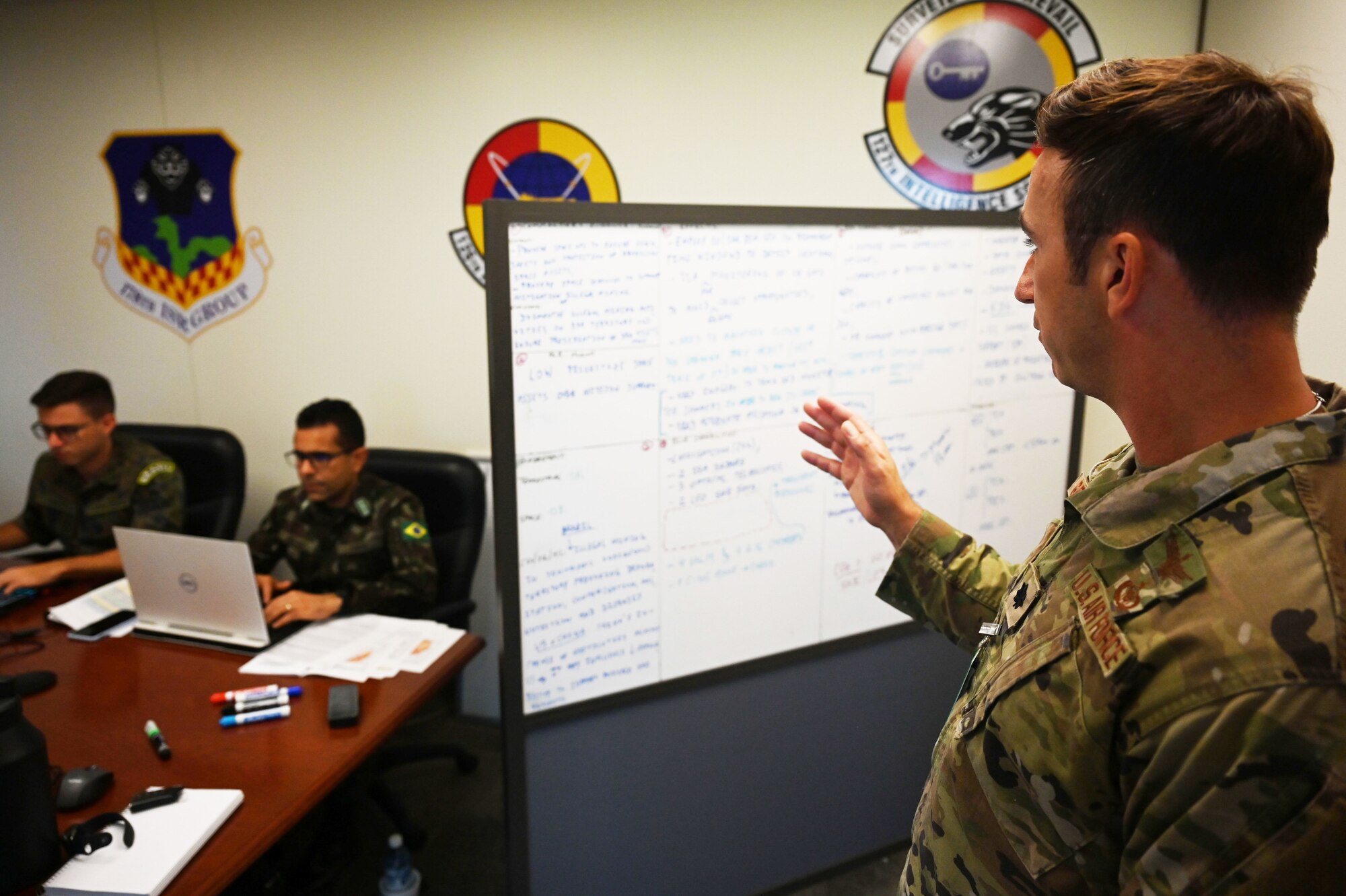 Lt. Col. Graziano goes over the days exercise with Brazilian military personnel.