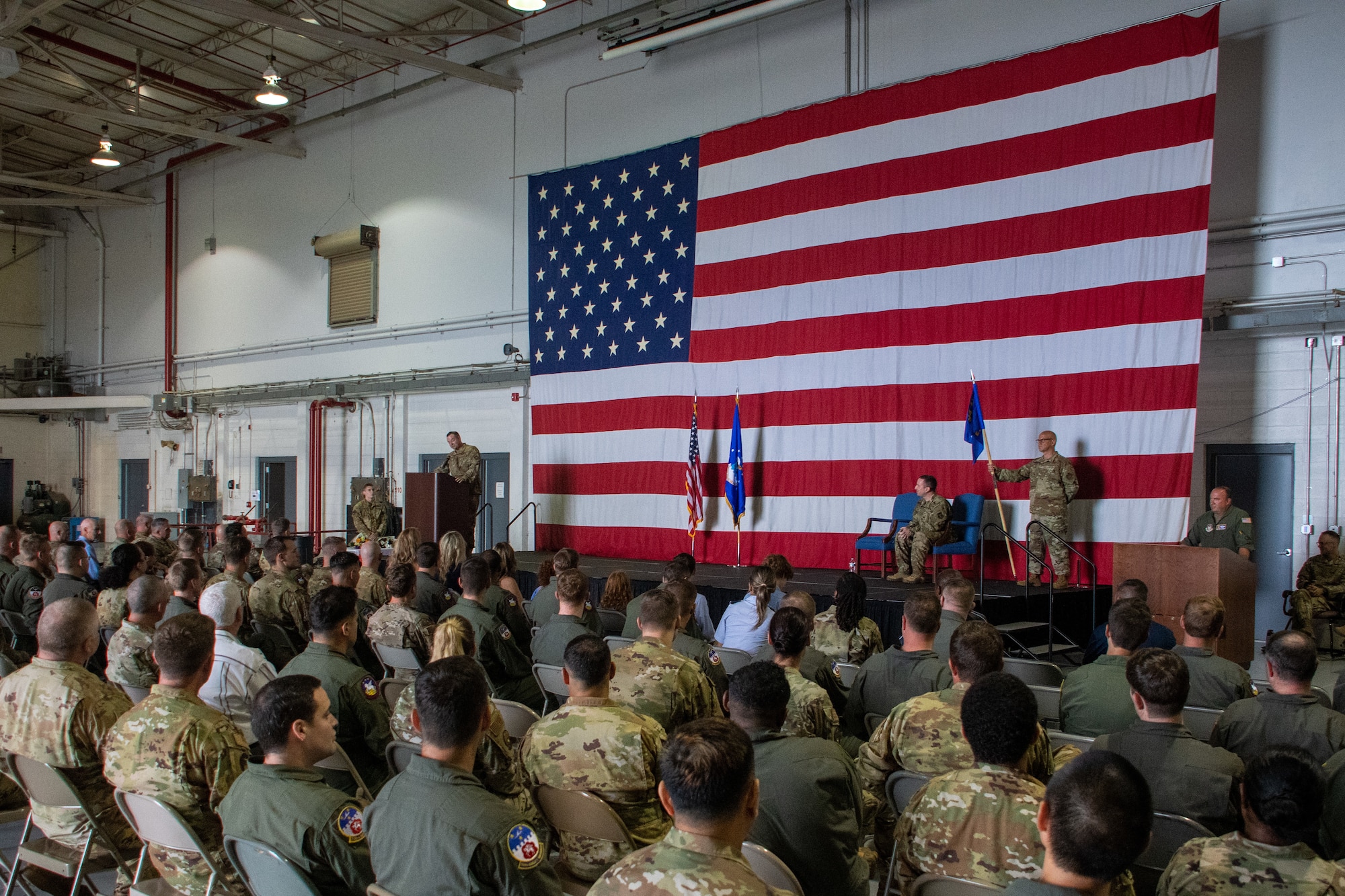 a crowd is seated for a ceremony
