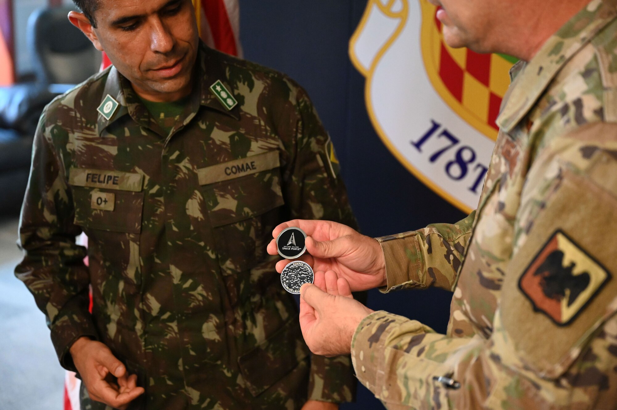 Major General Vaughan presents coins to the brazilian military members participating in the Vulcan Guard exercise.