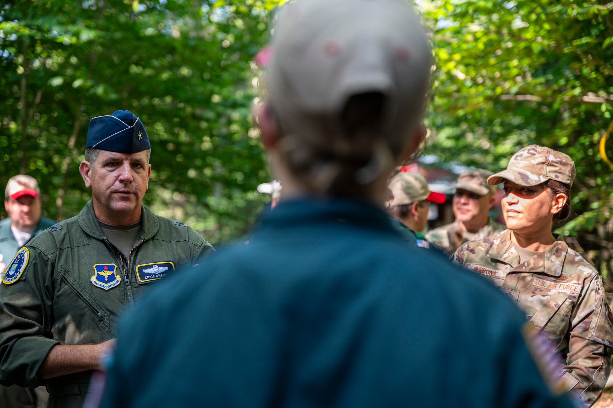 U.S. Air Force Brig. Gen. Christopher Amrhein (left), Air Force Recruiting Service commander, and Chief Master Sgt. Rebecca Arbona, AFRS command chief, speak to Boy Scouts of America staff and camp counselors at Camp Minsi in Pocono Summit, Penn., July 22, 2023.