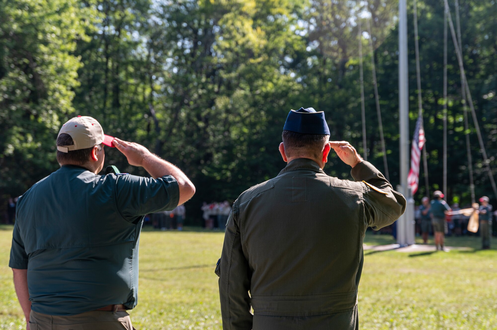 U.S. Air Force Brig. Gen. Christopher Amrhein (right), Air Force Recruiting Service commander, and James Feuerstein, camp director for boy Scouts of America’s Camp Minsi, salute the flag during the camp’s closing ceremony in Pocono Summit, Penn., July 22, 2023.
