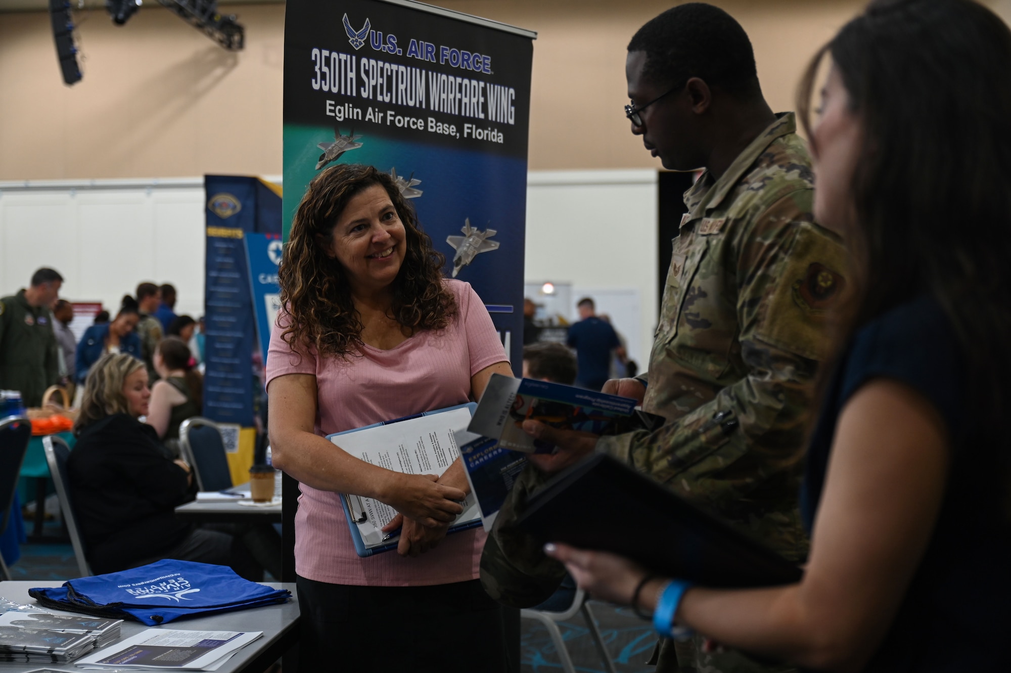 Traci L. Baart, 350th Spectrum Warfare Wing civilian personnel program specialist, talks with various individuals during a career summit at Fort Walton Beach, Fla., Aug. 17, 2023. The in-person event brought together employers and job seekers who are currently ready to work as well as those planning for the future. (U.S. Air Force photo by Staff Sgt. Ericka A. Woolever)