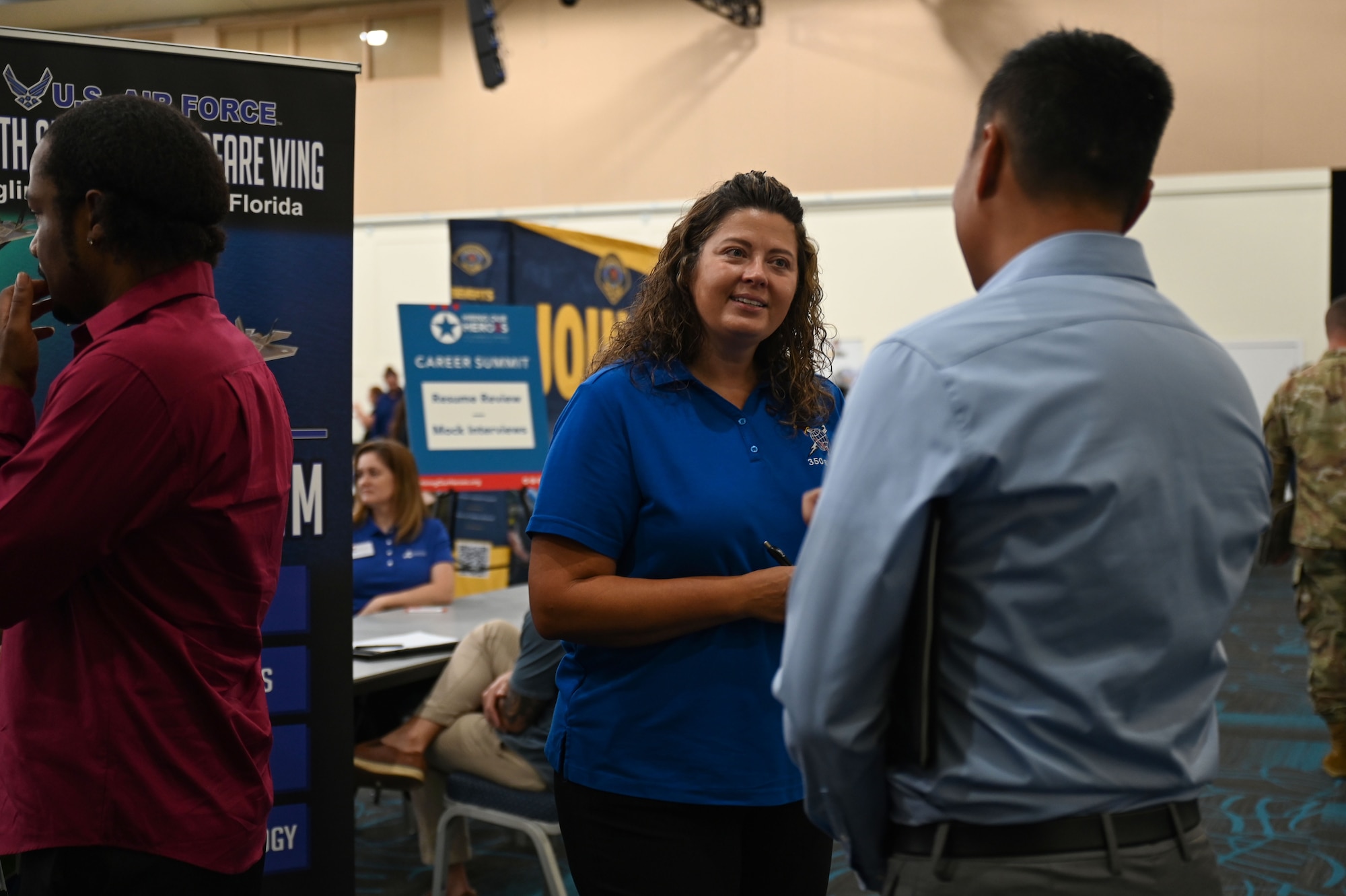 Misty D. Hutchison, 350th Spectrum Warfare Wing civilian personnel program specialist, talks to job seekers during a career summit at Fort Walton Beach, Fla., Aug. 17, 2023. The 350th SWW encourages calculated risk taking, wingmanship, professional development and gives members opportunities to contribute to capabilities that support warfighters. (U.S. Air Force photo by Staff Sgt. Ericka A. Woolever)