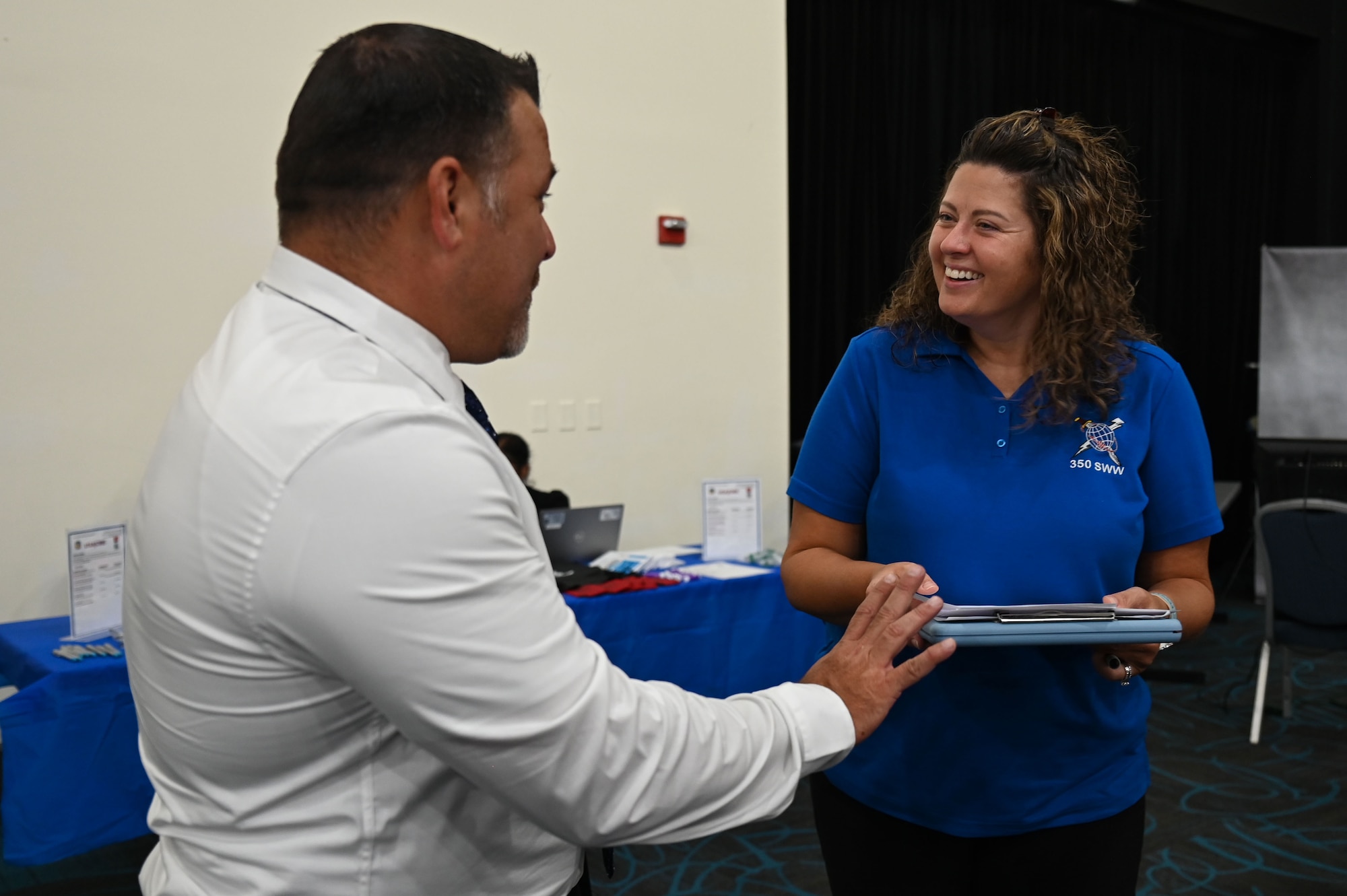Misty D. Hutchison, 350th Spectrum Warfare Wing civilian personnel program specialist, talks with job seekers during a career summit at Fort Walton Beach, Fla., Aug. 17, 2023. At the 350th SWW, members are given the opportunity to deliver adaptive and cutting-edge electromagnetic spectrum capabilities that provide the warfighter a tactical and strategic competitive advantage and freedom to attack, maneuver, and defend. (U.S. Air Force photo by Staff Sgt. Ericka A. Woolever)