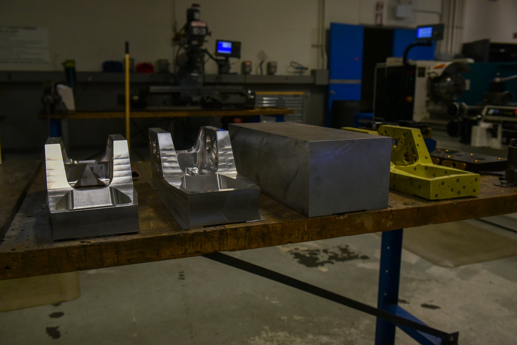 Several prototypes of the jackscrew mounting brackets used on KC-135 stratotankers are displayed on a table at Fairchild Air Force Base, July 24, 2023. The jack screw is an essential part of the KC-135 Stratotanker that was remade from old blueprints by Fairchild AFB’s metal tech shop. (U.S. Air Force photo by Airman 1st Class Lillian Patterson)