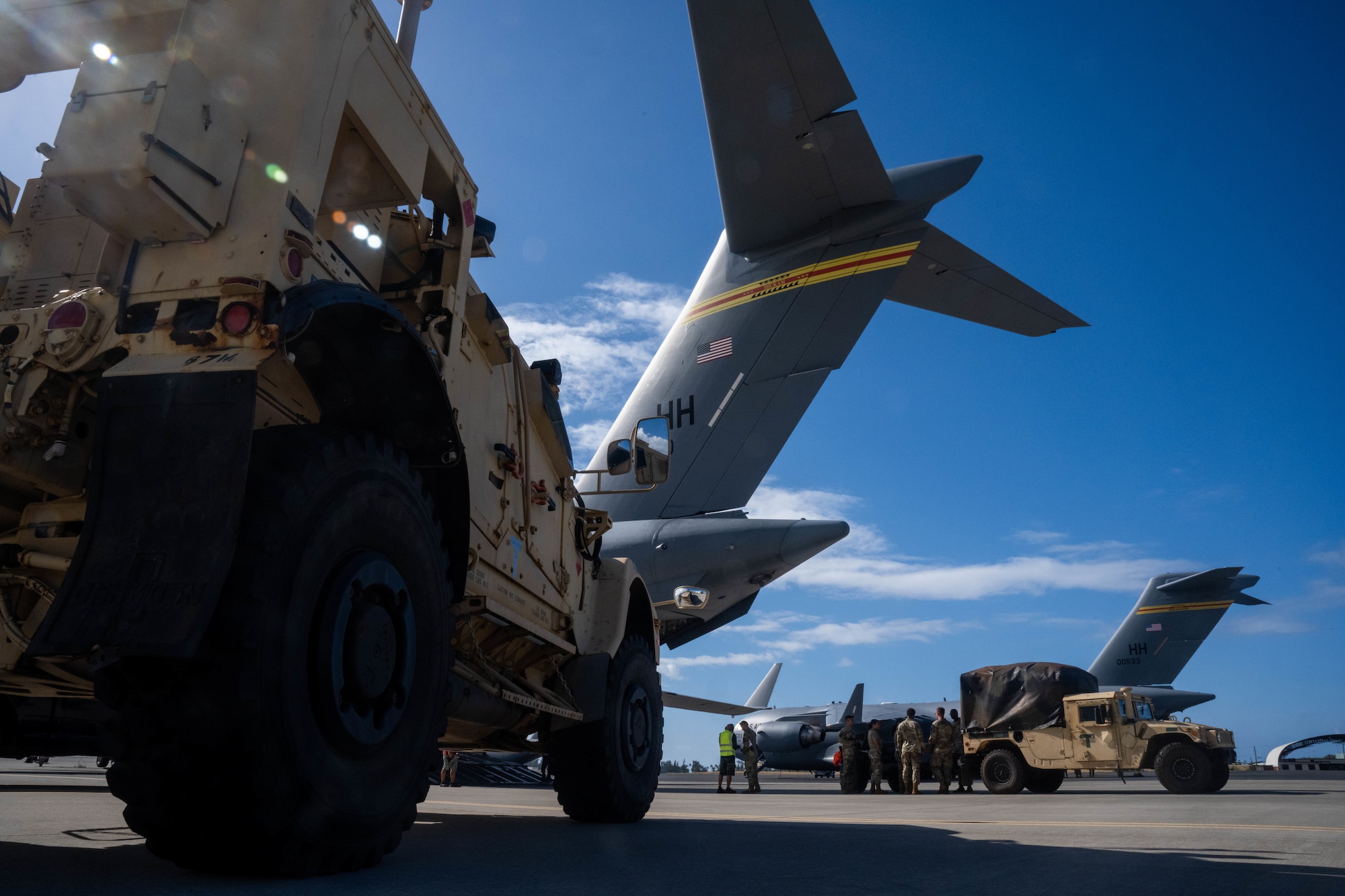 U.S. Army equipment is loaded on a C-17 Globemaster III during an exercise at Joint Base Pearl Harbor-Hickam, Hawaii, August 1, 2023. Team Hickam Airmen provided airlift capabilities to over 50 U.S. Army soldiers in support of Exercise Mungadai, a week-long leadership training exercise. (U.S. Air Force photo by Senior Airman Makensie Cooper)
