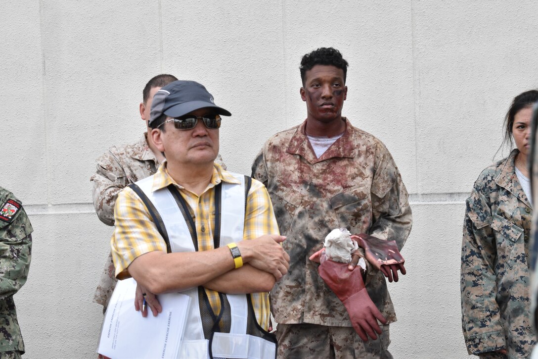 Several key members of Combined Arms Training Center, Camp Fuji, discuss their response after Exercise Mamoru concludes, August 17, 2023. The mass casualty exercise was designed to see how Marines and base first responders could potentially help and evacuate wounded individuals at the small installation. Mamoru is a Japanese word, it means - to protect.  (U.S. Marine Corps photo by Song Jordan)