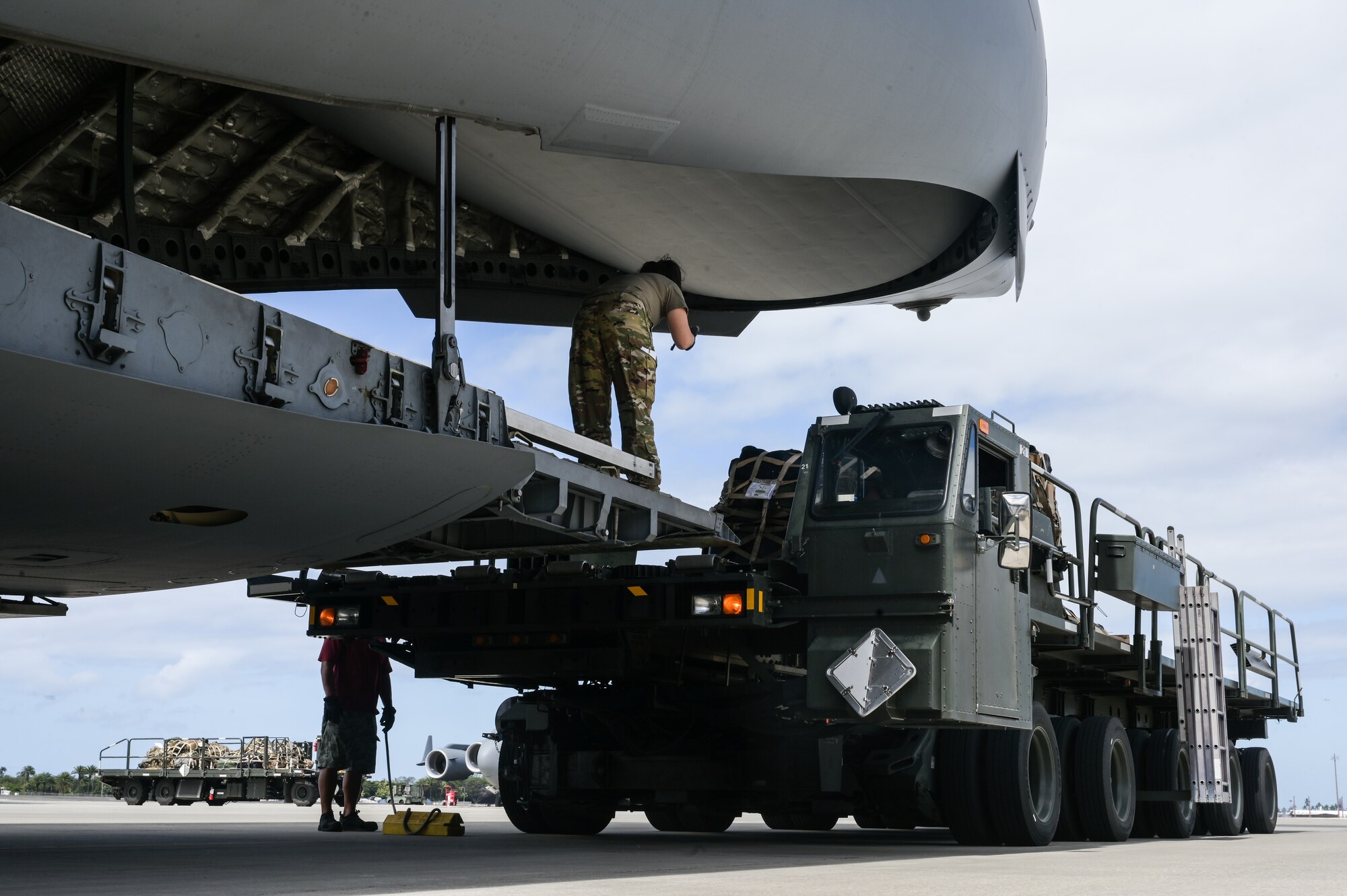 U.S. Army equipment is loaded on a C-17 Globemaster III during an exercise at Joint Base Pearl Harbor-Hickam, Hawaii, August 1, 2023. Team Hickam Airmen provided airlift capabilities to over 50 U.S. Army soldiers in support of Exercise Mungadai, a week-long leadership training exercise. (U.S. Air Force photo by Staff Sgt. Alan Ricker)