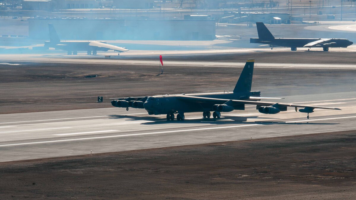 A large airplane taxis on a runway.