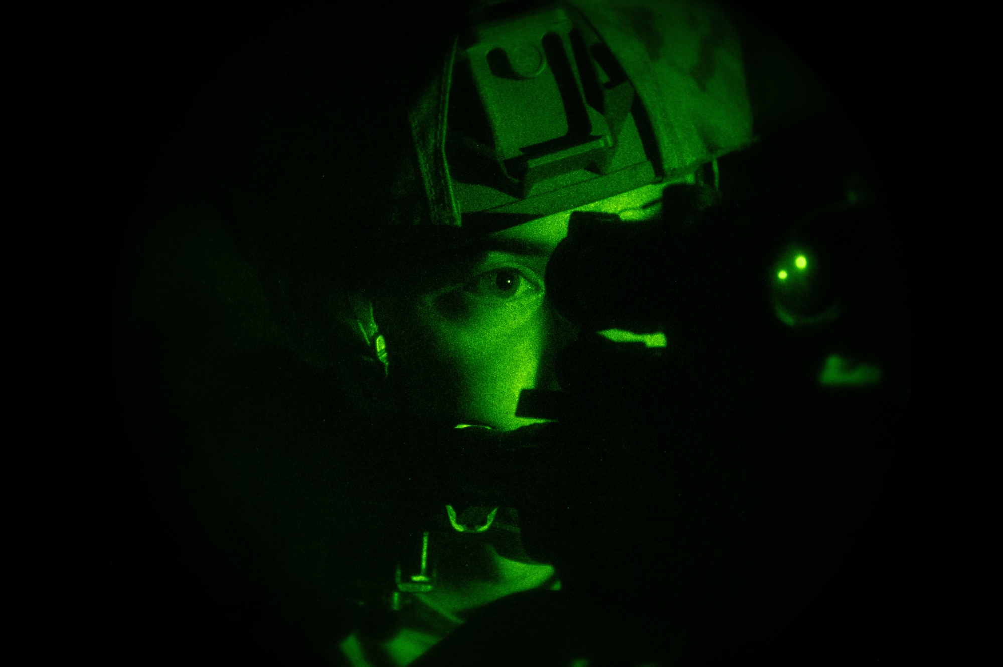 U.S. Air Force Staff Sgt. Gabriel Santiago, 51st Security Forces Squadron Defender, scans the area for opposing forces (OPFOR) during a simulated ground attack at Osan AB, Republic of Korea, Aug. 3, 2023. During these scenarios, OPFOR is strategically hidden around the area to mimic potential real-world threats. (U.S. Air Force photo by Staff Sgt. Thomas Sjoberg)