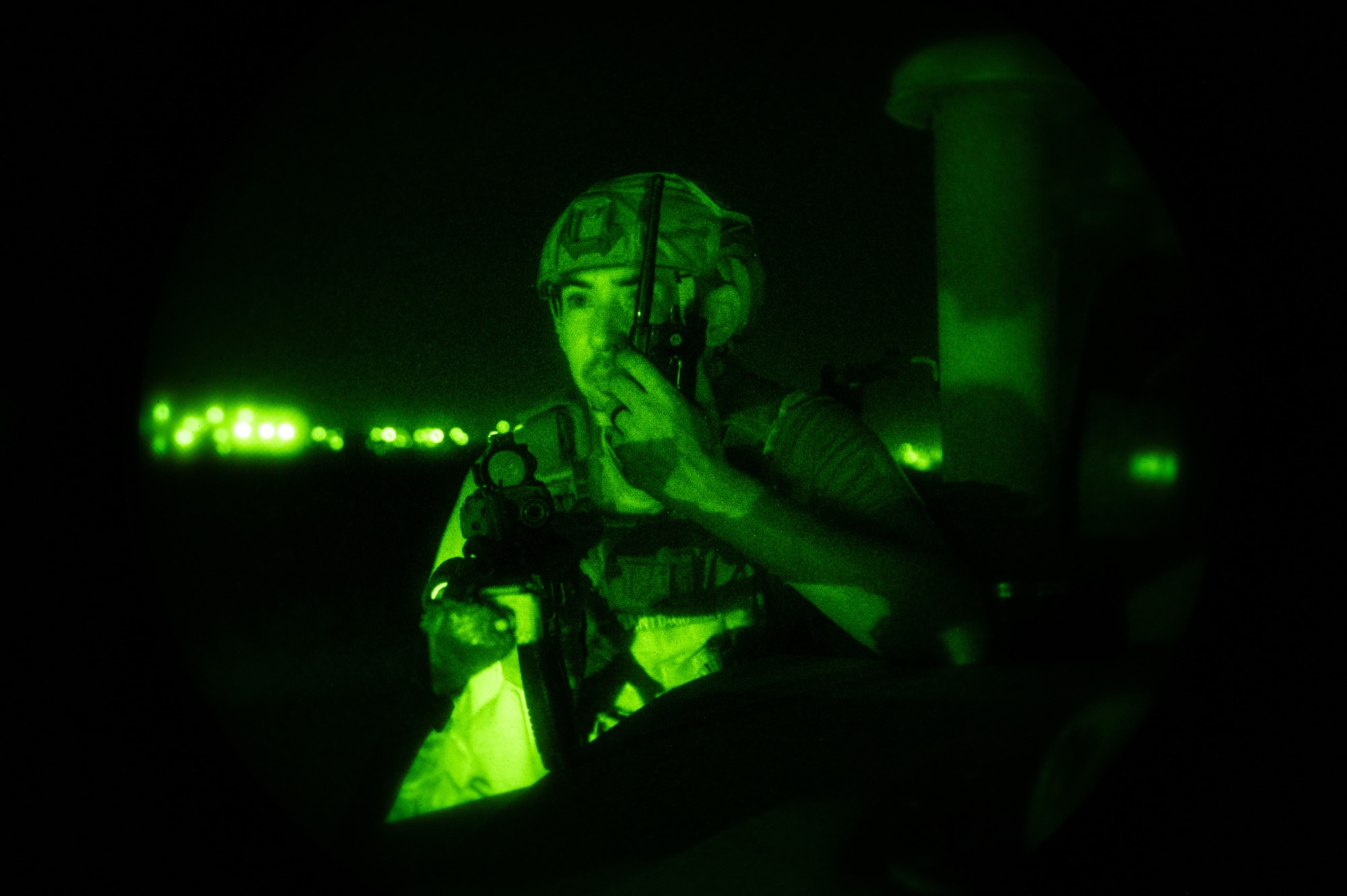A U.S. Air Force Staff Sgt. Gabriel Santiago, 51st Security Forces Squadron Defender, communicates with his team during a simulated ground attack at Osan Air Base, Republic of Korea, Aug. 3, 2023. The ground attacks allow Defenders to develop and refine their tactics, techniques, and procedures in response to different enemy scenarios. (U.S. Air Force photo by Staff Sgt. Thomas Sjoberg)