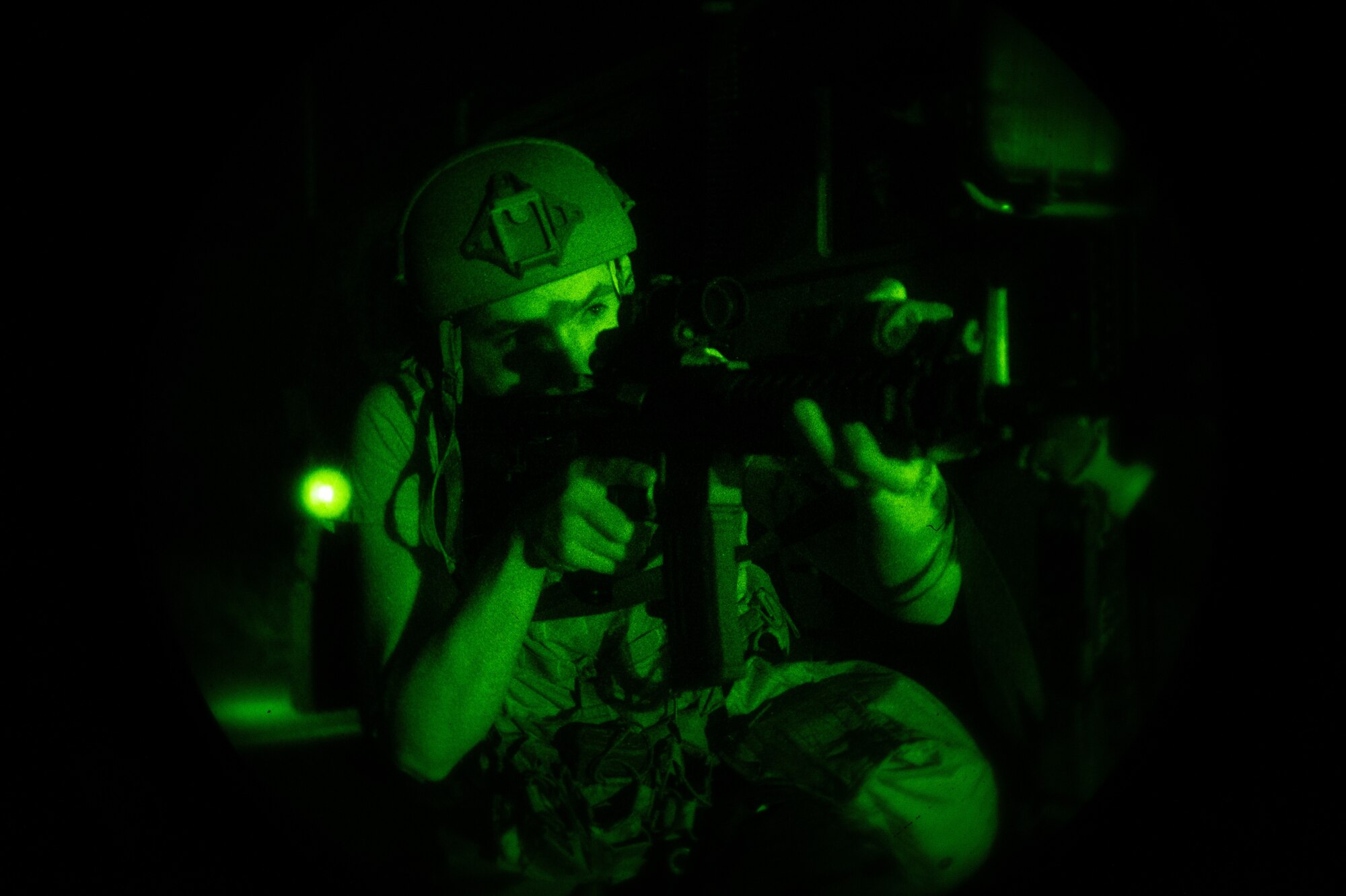 U.S. Air Force Staff Sgt. Gabriel Santiago, 51st Security Forces Squadron Defender, scans the area for opposing forces (OPFOR) during a simulated ground attack at Osan AB, Republic of Korea, Aug. 3, 2023. During these scenarios, OPFOR is strategically hidden around the area to mimic potential real-world threats. (U.S. Air Force photo by Staff Sgt. Thomas Sjoberg)