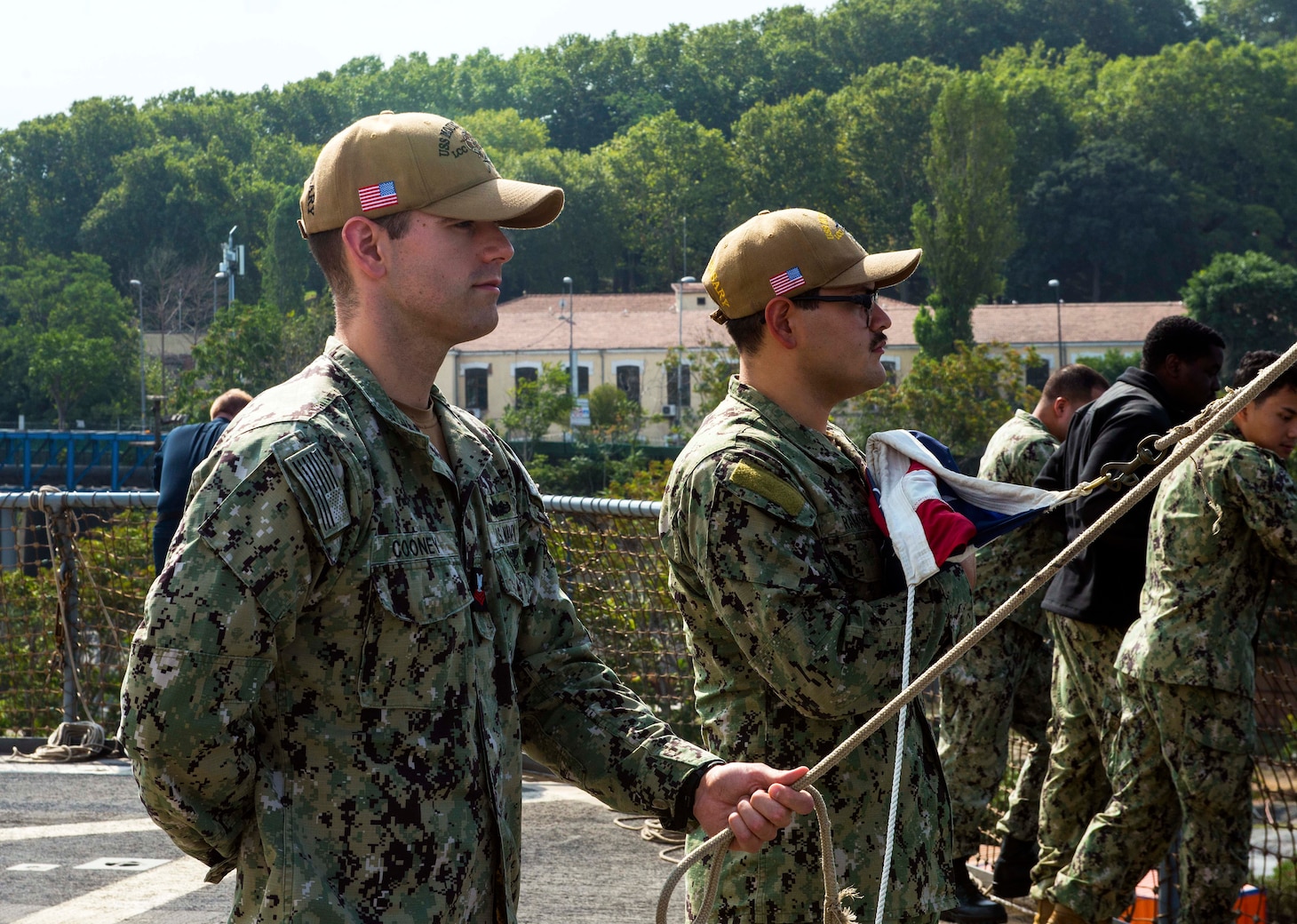 230818-N-JC445-1008 ISTANBUL, Türkiye (August 18, 2023) Hospital Corpsman 1st Class Donald Cooney and Interior Communications Electrician 3rd Class Alexander Ramirez prepare to raise the Ensign aboard the Blue Ridge-class command and control ship USS Mount Whitney (LCC 20). Mount Whitney, the U.S. Sixth Fleet flagship, is on a scheduled visit to Türkiye, in support of U.S., allied, and partner interests. Homeported in Gaeta, Mount Whitney operates with a combined crew of U.S. Sailors and Military Sealift Command civil service mariners. (U.S. Navy photo by Mass Communication Specialist 2nd Class Mario Coto)