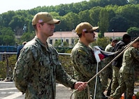 230818-N-JC445-1008 ISTANBUL, Türkiye (August 18, 2023) Hospital Corpsman 1st Class Donald Cooney and Interior Communications Electrician 3rd Class Alexander Ramirez prepare to raise the Ensign aboard the Blue Ridge-class command and control ship USS Mount Whitney (LCC 20). Mount Whitney, the U.S. Sixth Fleet flagship, is on a scheduled visit to Türkiye, in support of U.S., allied, and partner interests. Homeported in Gaeta, Mount Whitney operates with a combined crew of U.S. Sailors and Military Sealift Command civil service mariners. (U.S. Navy photo by Mass Communication Specialist 2nd Class Mario Coto)
