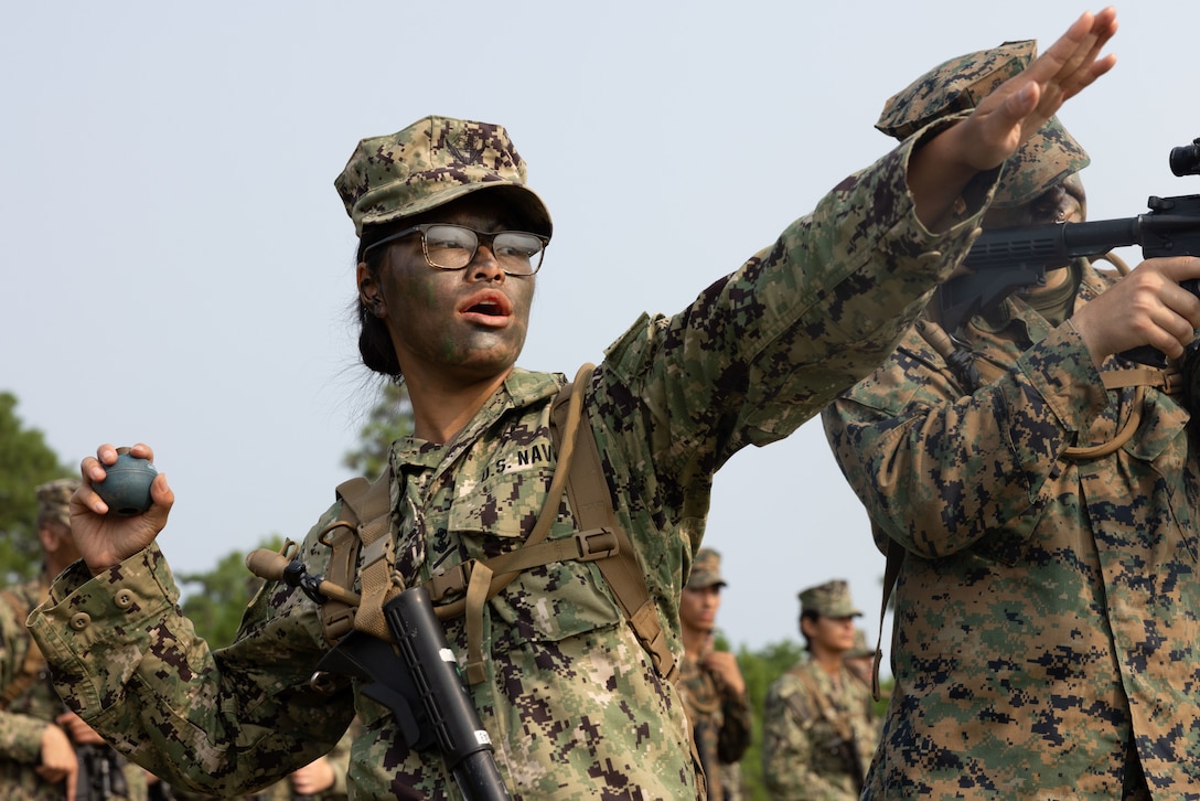 Naval Reserve Officers Training Corps (NROTC) Midshipman Ashlynn McNerney practices throwing an M67 grenade as part of Career Orientation Training for Midshipmen (CORTRAMID) on Camp Lejeune, North Carolina, August 2, 2023. The CORTRAMID is a basic introduction and training event to familiarize NROTC Midshipmen with the primary warfare designators that they will serve in, along with providing them with exposure to what is often their first fleet experience. (U.S. Marine Corps photo by Lance Cpl. Kylie Lake)