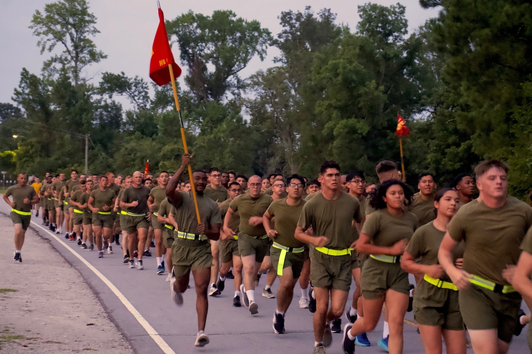 U.S. Marines with Headquarters Battalion, 2d Marine Division conduct a motivation run on Camp Lejeune, North Carolina, August 4, 2023. The Motivational run serves to boost camaraderie and unit cohesion while promoting physical fitness. (U.S. Marine Corps photo by Lance Cpl. Max Arellano)