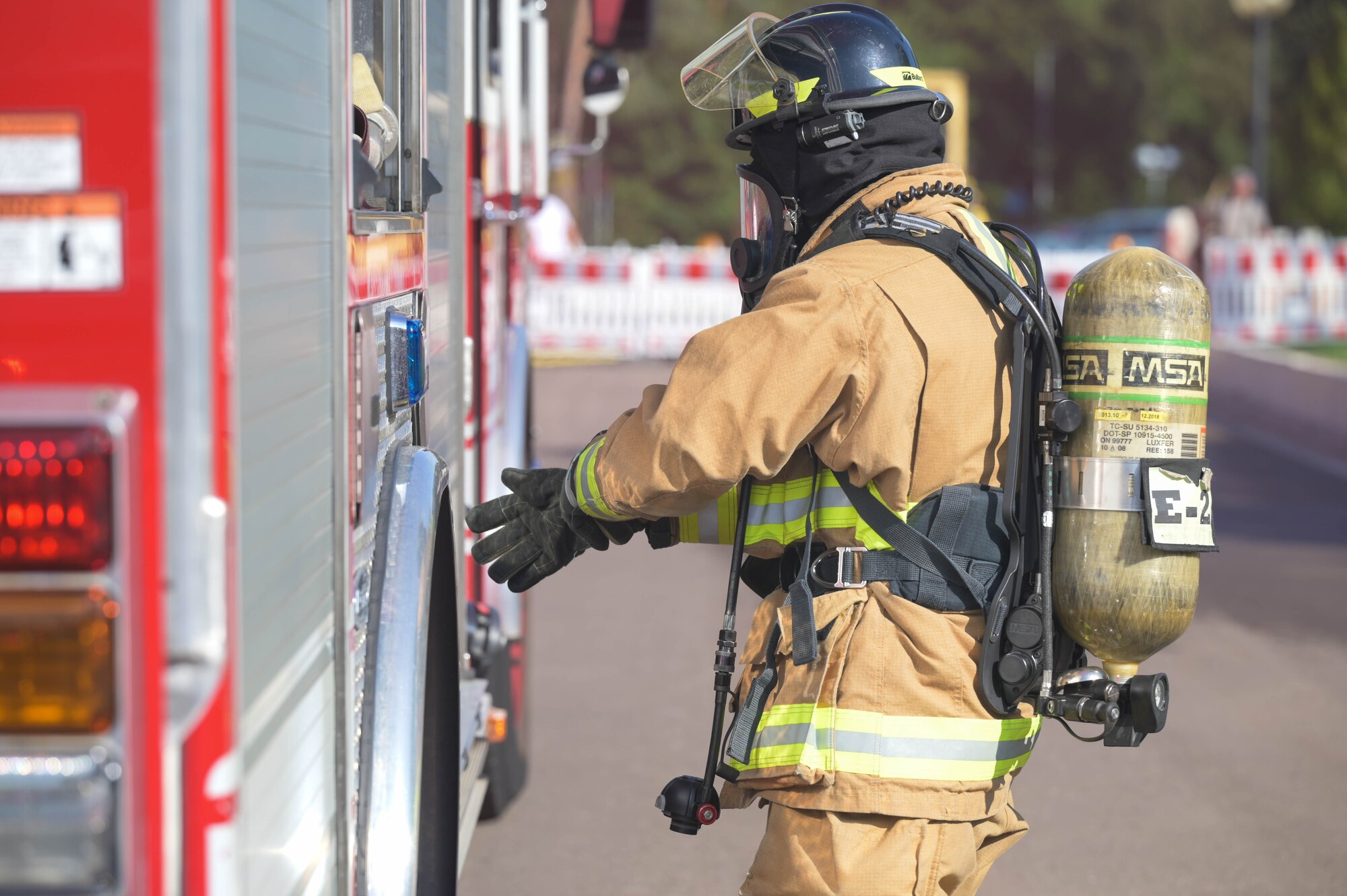 A U.S. Air Force firefighter with the 86th Airlift Wing dons protective equipment during Operation Varsity 23-3.
