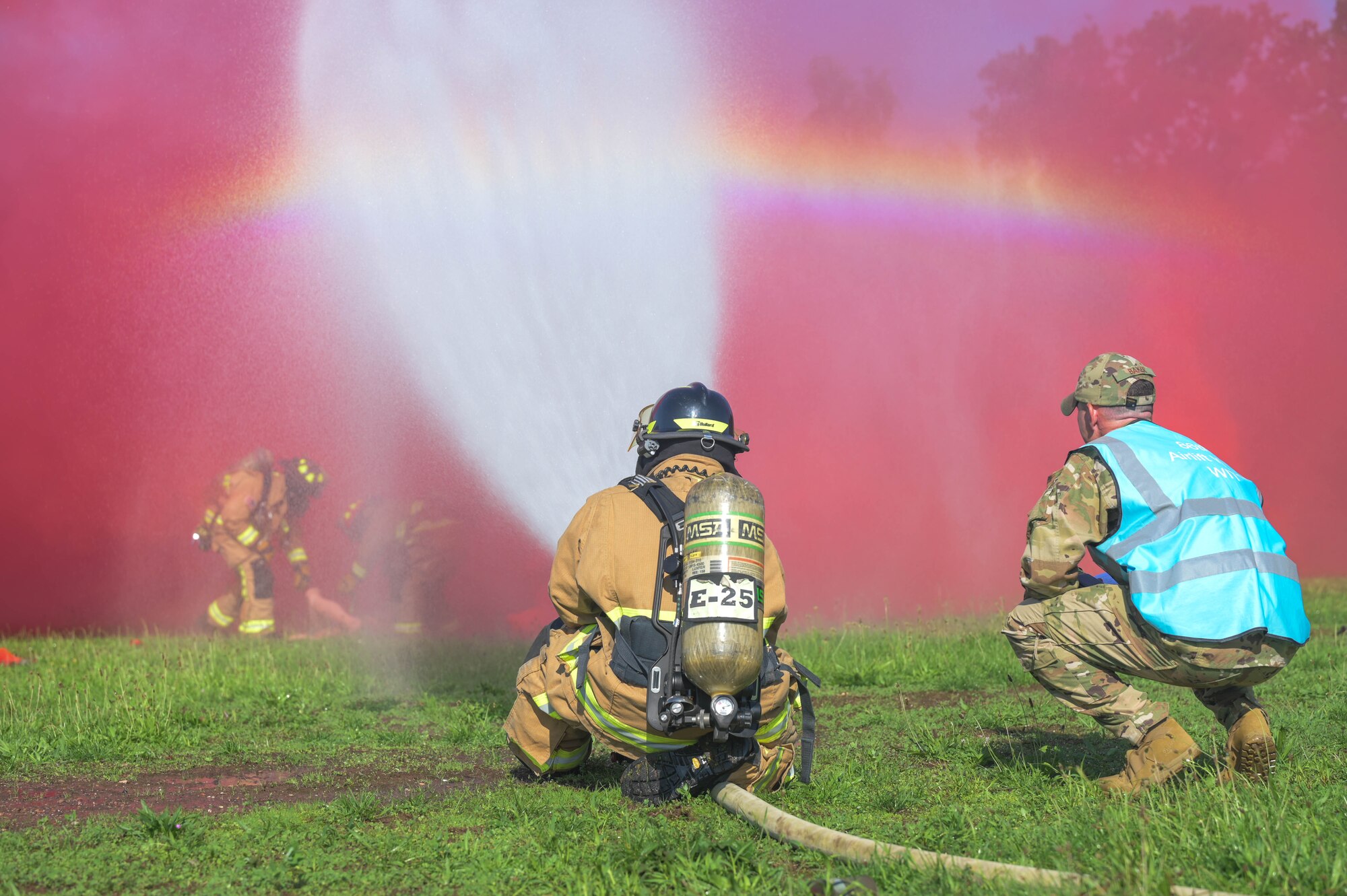 U.S. Air Force firefighters with the 86th Airlift Wing spray water onto a simulated fire and save a simulated victim during Operation Varsity 23-3.