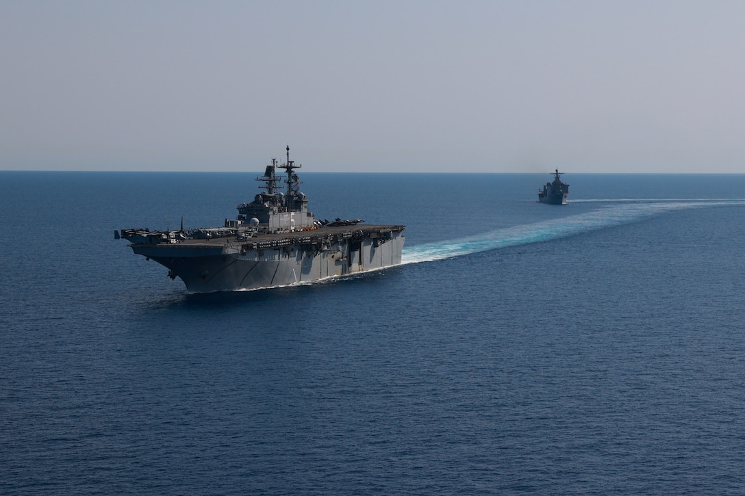 RED SEA (Aug. 8, 2023) Amphibious assault ship USS Bataan (LHD 5) and Dock landing ship USS Carter Hall (LSD 50) transit in formation through the Red Sea, Aug. 8, 2023. The Bataan Amphibious Ready Group and embarked (26th MEU SOC) Marine Expeditionary Unit Special Operations Capable, under the command and control of Task Force 51/5, is on a scheduled deployment in the U.S. Naval Forces Central Command area of operations, employed by U.S. Fifth Fleet to maintain maritime security and stability in the Middle East region. (U.S. Navy photo by Mass Communication Specialist 3rd Class Riley Gasdia)