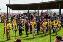 American Legion, American Legion Auxiliary, and Veterans of Foreign Wars members from the Mandan-Hidatsa-Arikara (MHA) Nation and other tribal nations lead the grand entry of the Little Shell Celebration in New Town, N.D., Aug. 12, 2023. During the grand entry, veterans carry their flags into the arena followed by hundreds of dancers dressed in traditional regalia. This tradition is one of many that honors the veterans and service members of MHA Nation.