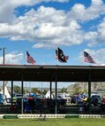 Three American flags and a POW/MIA flag fly proudly above the Mandan-Hidatsa-Arikara (MHA) Nation Little Shell Celebration arena, 13 Aug., 2023. The flags represent the veterans of each of the Three Affiliated Tribes, and by flying them, MHA Nation allows those who have passed to return and celebrate with their family and friends during the powwow.