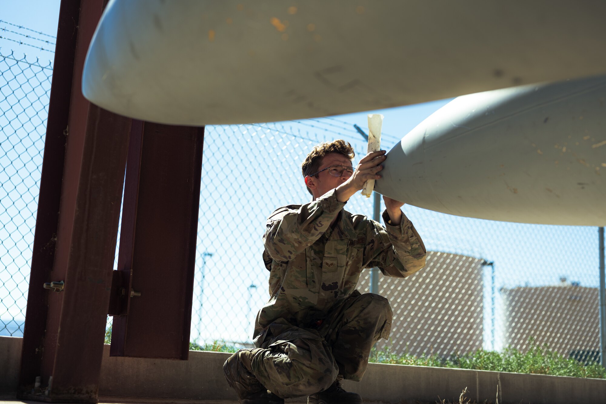 U.S. Air Force Senior Airman William Hunter, 49th Component Maintenance Squadron fuels systems journeyman, evaluates an F-16 Viper external fuel tank at Holloman Air Force Base, New Mexico, Aug. 10, 2023. This training helps to create Airmen who are skilled in different areas but it also fills any personnel gaps. (U.S. Air Force photo by Senior Airman Antonio Salfran)