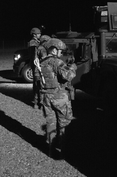 (A Defender from the 791st Missile Security Forces Squadron utilizes a night-vision goggle to clear out the mission vehicle before loading up. (U.S. Air Force courtesy photo)