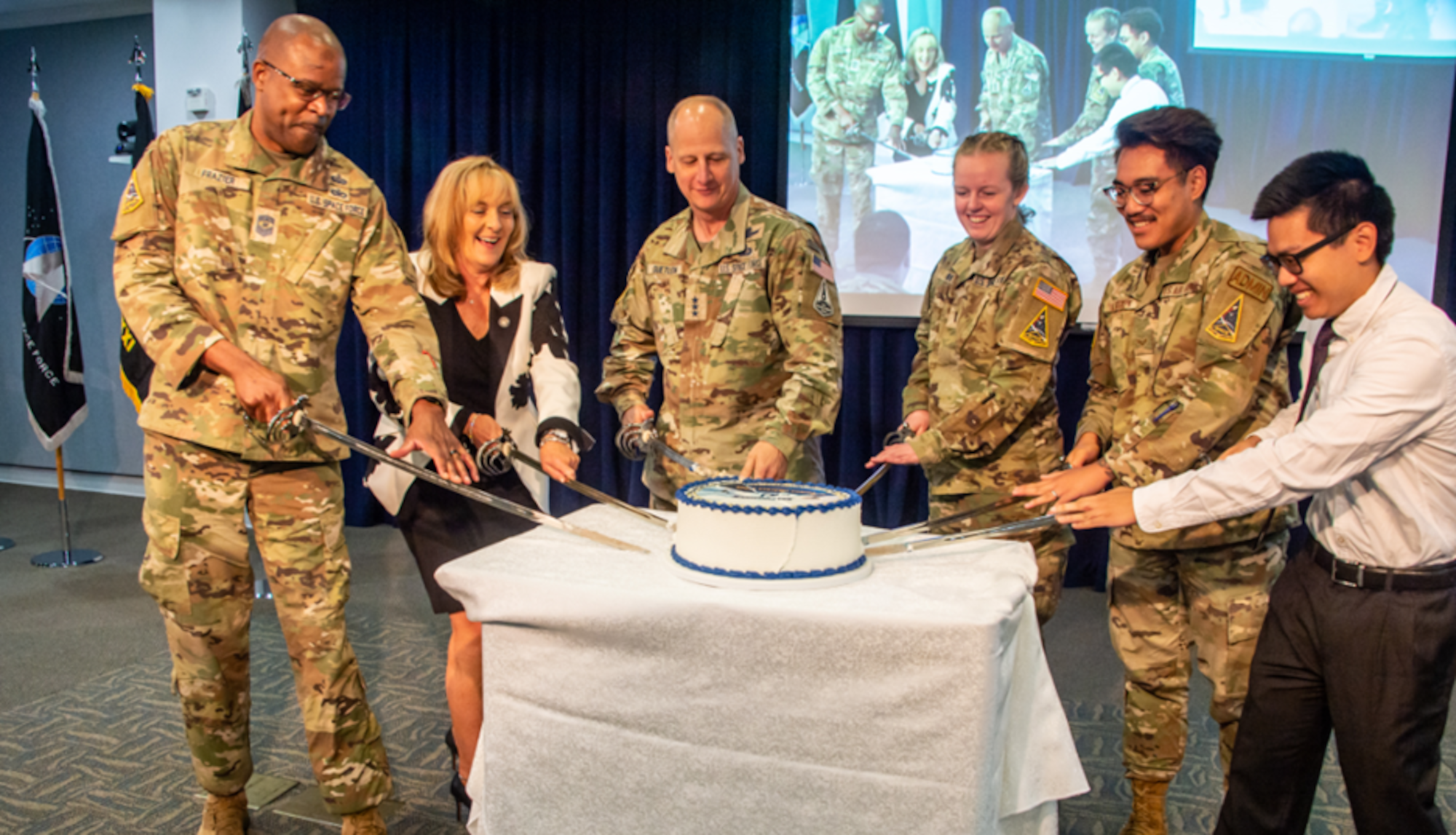 Space Systems Command (SSC) leadership represented by (left to right) Chief MSgt. Willie Frazier, senior enlisted leader; Ms. Joy White, executive director; and Lt. Gen. Michael Guetlein, commander; are joined by the youngest members of SSC’s Airmen, Guardians and civilian personnel: 2nd Lt. Samantha