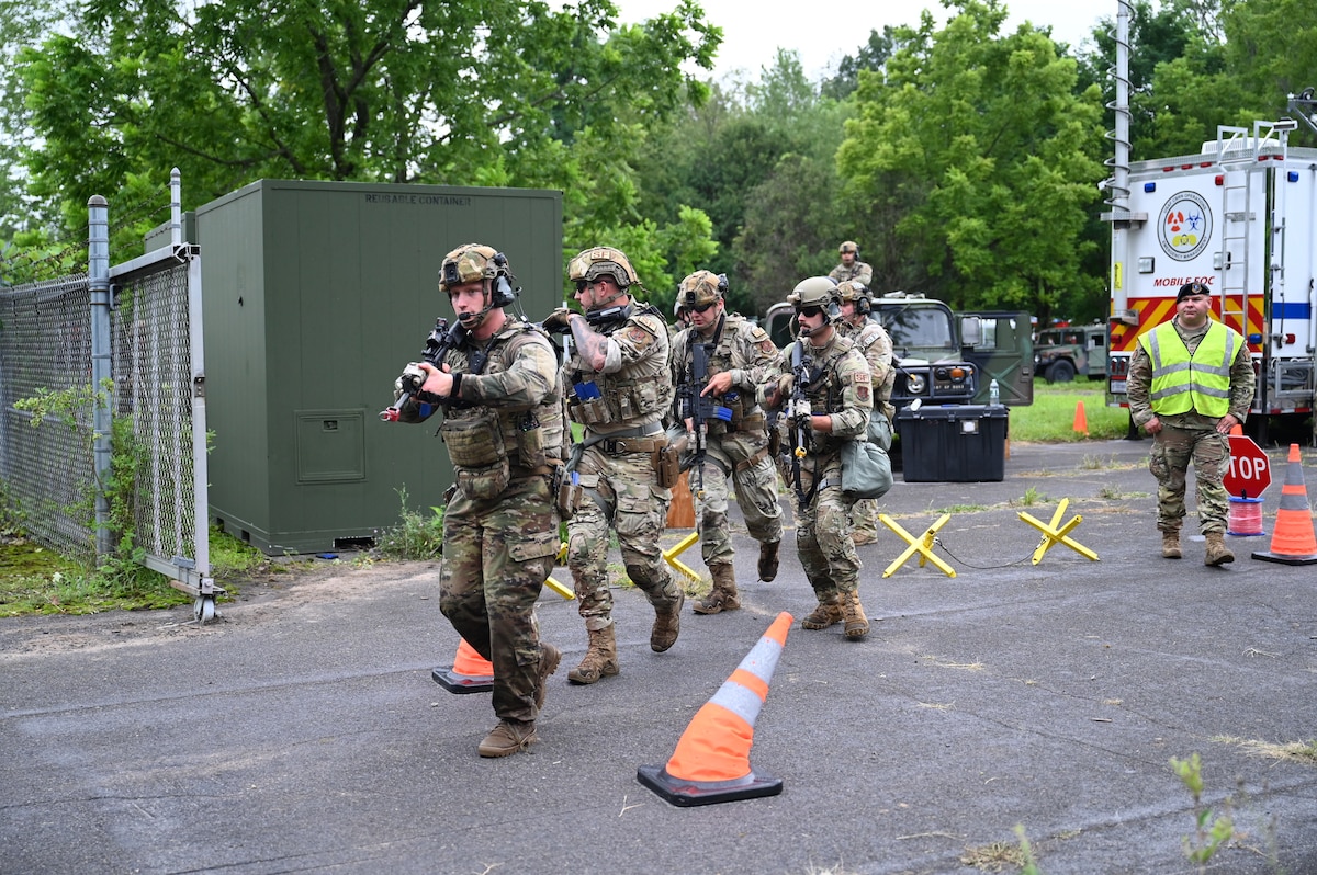 New York National Guard airmen from the 174th Attack Wing’s mission support group, man the perimeter of a simulated forward operating site located at Hancock Field Air National Guard Base in Syracuse New York on August 7, 2023. One hundred and twenty Airmen worked together to set-up a simulated forward operating site and used their training to overcome chemical, biological, and weapon threats coming in from an enemy force as well as responding to emergencies. (U.S. Air National Guard photo by Airman Tiffany Scofield.)