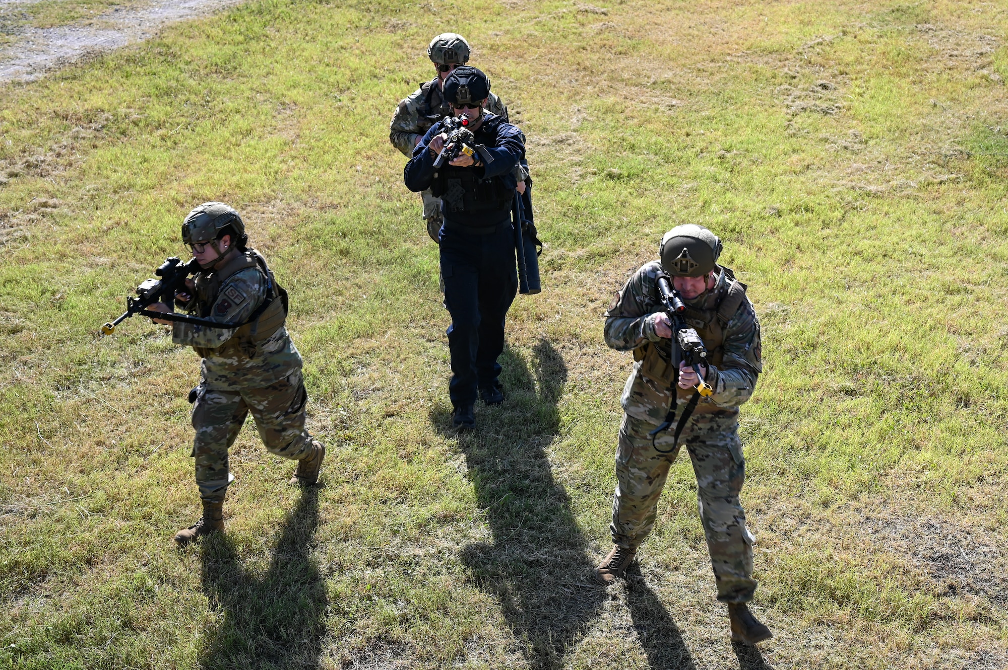 U.S. Air Force Airmen from the 47th Security Forces Squadron prepare to clear a simulated barricaded building during a base tour with the U.S. Border Patrol, Del Rio Sector leadership and the Val Verde County Sheriff's Department at Laughlin Air Force Base, Texas, Aug. 4, 2023. The Airmen demonstrated their ability to clear buildings to showcase their capabilities. (U.S. Air Force photo by Airman 1st Class Keira Rossman)