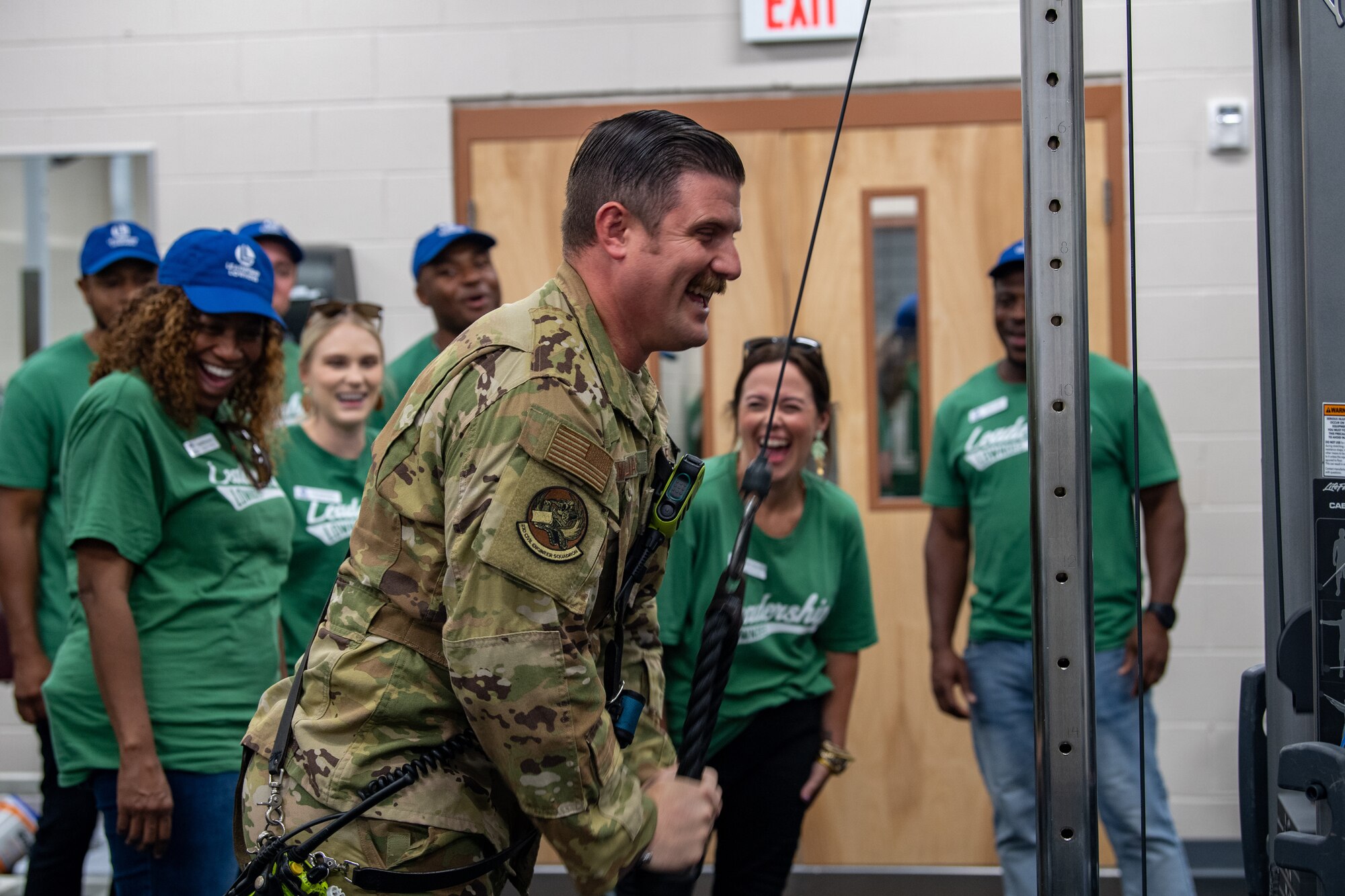 U.S. Air Force Staff Sgt. Logan Williams, 23rd Civil Engineer Squadron lead firefighter, demonstrates a tricep pulldown during Defense Day at Moody Air Force Base, Georgia, Aug. 17, 2023. The Leadership Lowndes class participated in the Defense Day tour to gain a better understanding of the personal and professional goals of Airmen at Moody AFB and network with base organizations to better support personnel on base. (U.S. Air Force photo by Senior Airman Courtney Sebastianelli)
