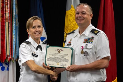 Brig. Gen. Paige M. Jennings, U.S. Army Financial Management Command commanding general, presents a Meritorious Service Medal to Sgt. Maj. John J. O’Connor, USAFMCOM Operations senior enlisted advisor, at the Maj. Gen. Emmett J. Bean Federal Center in Indianapolis Aug. 11, 2023. O’Connor was appointed to command sergeant major from sergeant major prior to his upcoming move to serve at the Warrior Transition Unit at Fort Belvoir, Virginia. (U.S. Army photo by Mark R. W. Orders-Woempner)