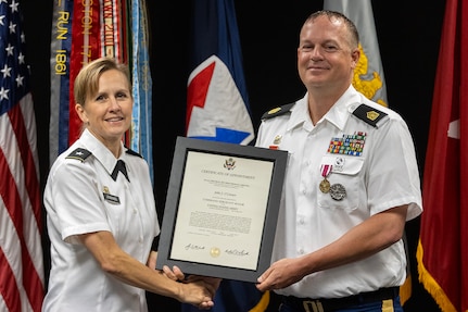 Brig. Gen. Paige M. Jennings, U.S. Army Financial Management Command commanding general, presents a certificate of appointment to Command Sgt. Maj. John J. O’Connor, USAFMCOM Operations senior enlisted advisor, prior to him pinning on his rank at the Maj. Gen. Emmett J. Bean Federal Center in Indianapolis Aug. 11, 2023. O’Connor was appointed to command sergeant major from sergeant major prior to his upcoming move to serve at the Warrior Transition Unit at Fort Belvoir, Virginia. (U.S. Army photo by Mark R. W. Orders-Woempner)