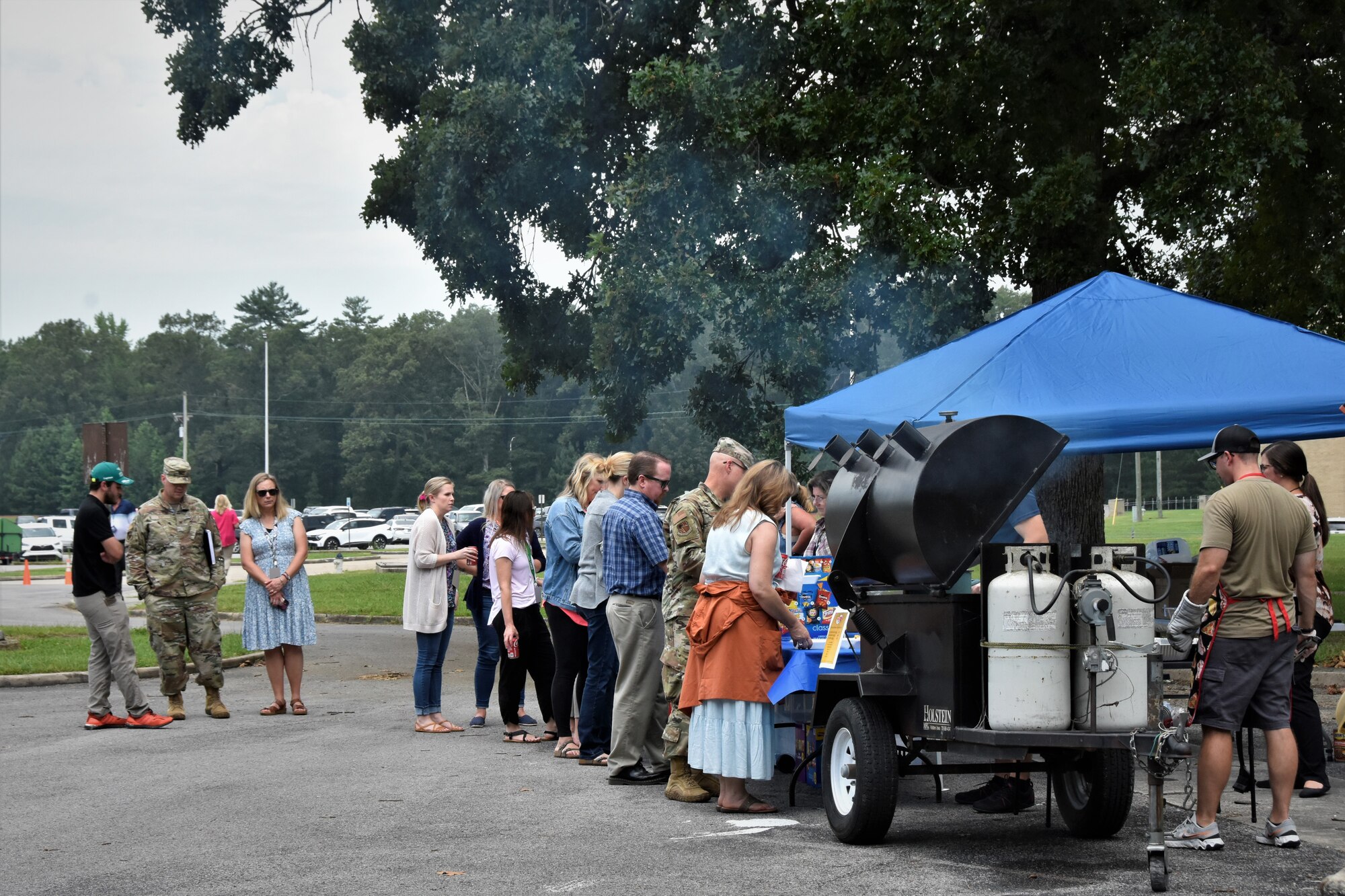 1st Lt. John Simpson, far right, mans the grill preparing hamburgers for base personnel July 27, 2023, during the Burger Burn and Car Show hosted by the Arnold Air Force Base Company Grade Officers’ Council at Arnold AFB, Tenn. All proceeds from the event benefit the upcoming Arnold Engineering Development Complex Air Force Ball that will take place in September in recognition of the Air Force 76th birthday. (U.S. Air Force photo by Brooke Brumley)