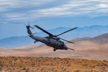 Helicopter flies in dessert.