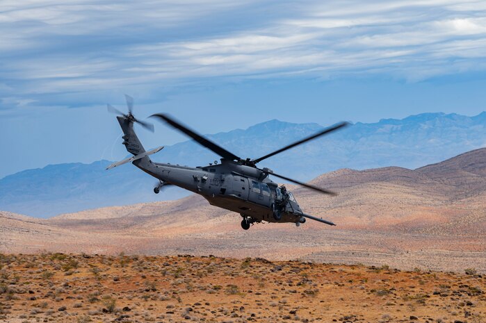 Helicopter flies in dessert.