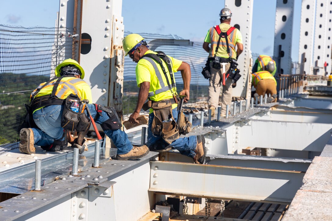 Photo shows contractors working on bridge repairs