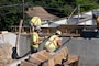 Photo shows contractors working on a bridge
