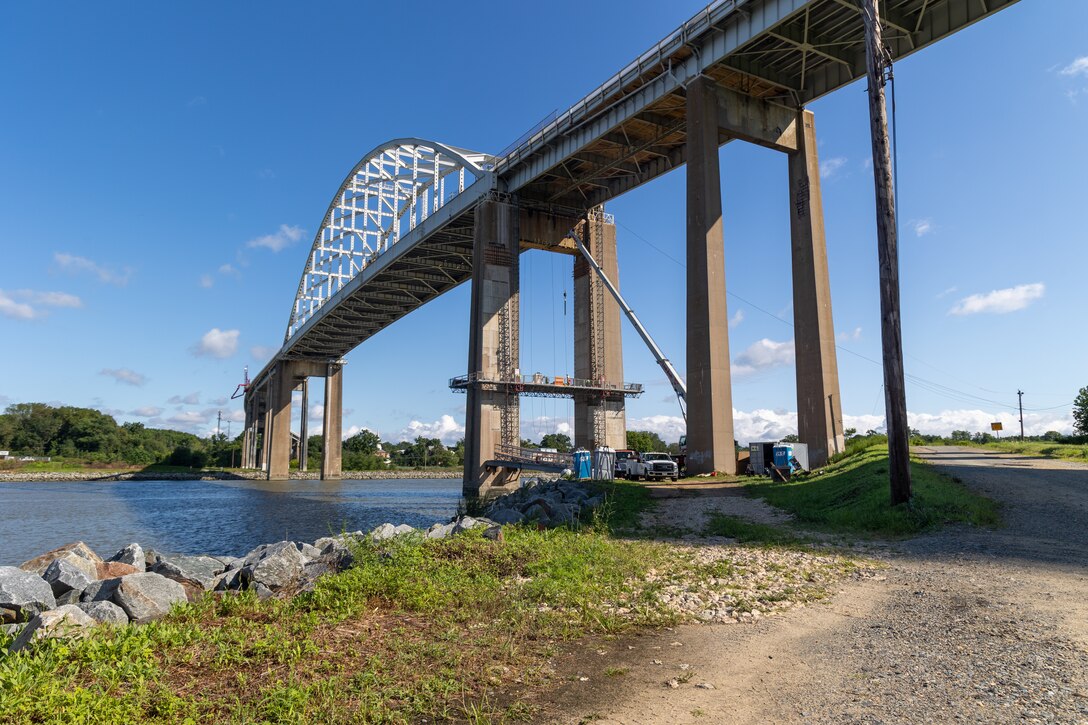 Photo shows a bridge above a waterway