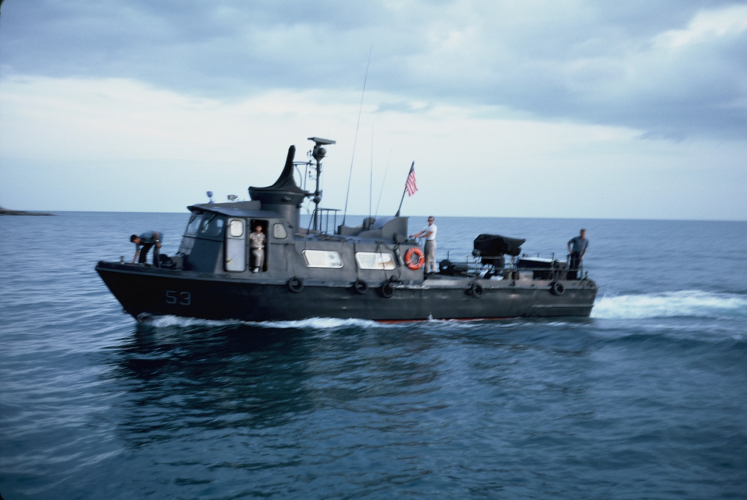 Lt. j.g. William Collins stands aboard patrol craft fast 53 with his crewmates.