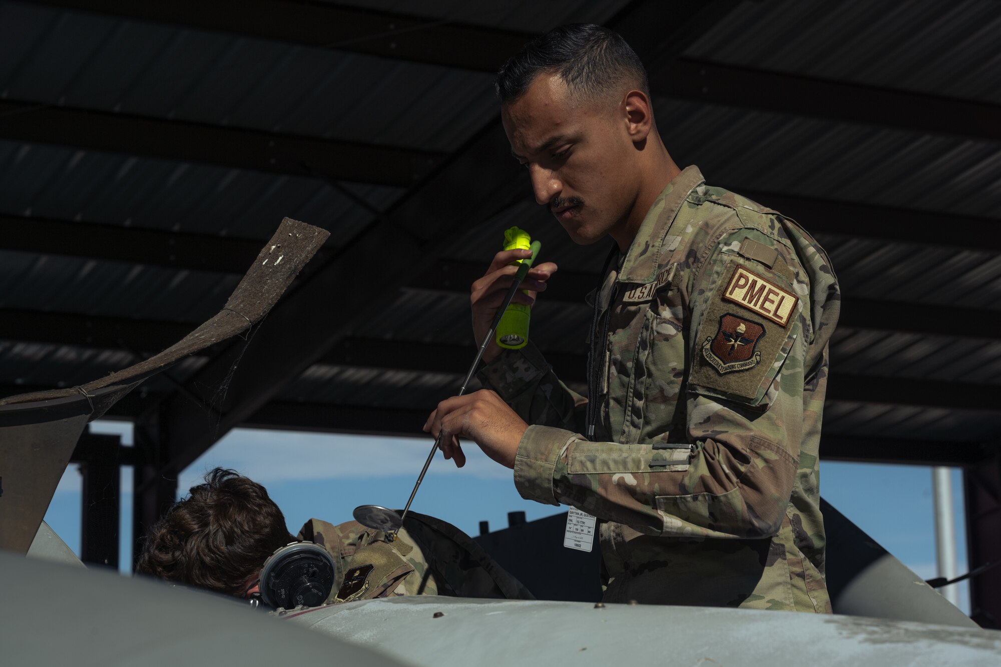 U.S. Air Force Senior Airman Gustavo Gaytan, 49th Component Maintenance Squadron precision measurement equipment laboratory journeyman, conducts a fuel tank inspection at Holloman Air Force Base, New Mexico, Aug. 10, 2023. The PMEL flight sent personnel to assist the fuels section, which helps the fuels members develop more realistic timelines and facilitate any unbalanced workloads, in turn allowing Airmen to be an active vessel in the multi-capable Airmen concept. (U.S. Air Force photo by Senior Airman Antonio Salfran)