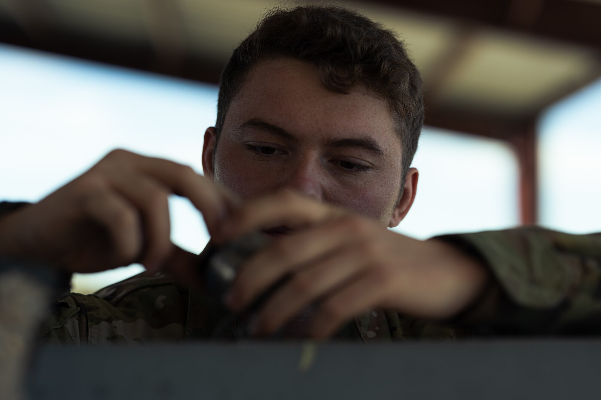 U.S. Air Force Airman 1st Class Cameron Kelley, 49th Component Maintenance Squadron fuels systems journeyman, examines the fuel valve on an F-16 Viper external fuel tank at Holloman Air Force Base, New Mexico, Aug. 10, 2023. The inspections and maintenance that the 49th CMS fuel shop provides is crucial to keeping the largest F-16 formal training unit running. (U.S. Air Force photo by Senior Antonio Salfran)